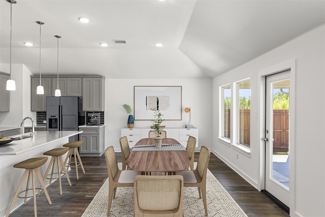 dining room with dark wood-style flooring, recessed lighting, visible vents, vaulted ceiling, and baseboards