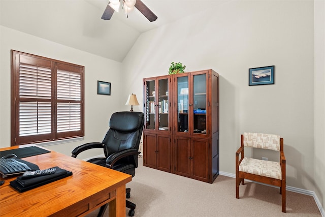 carpeted office featuring lofted ceiling, a ceiling fan, and baseboards