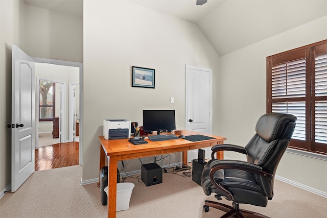 office space with high vaulted ceiling, carpet flooring, and baseboards