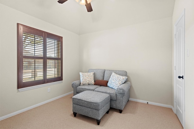 living area featuring ceiling fan, carpet flooring, and baseboards