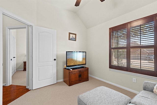 sitting room featuring carpet floors, vaulted ceiling, and a ceiling fan