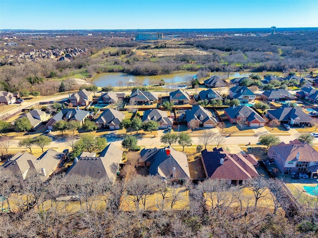 drone / aerial view featuring a water view and a residential view