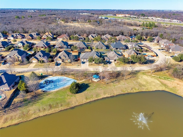 drone / aerial view featuring a residential view and a water view