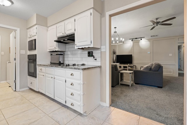 kitchen featuring visible vents, decorative backsplash, open floor plan, under cabinet range hood, and black appliances