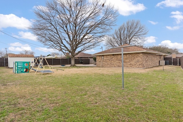 view of yard with a fenced backyard and a playground