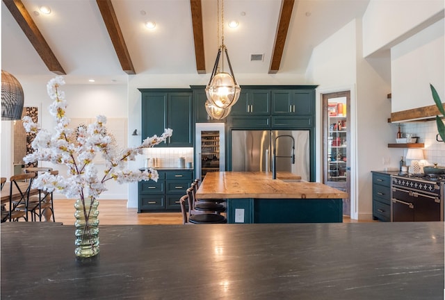 kitchen featuring premium appliances, visible vents, backsplash, wood counters, and beamed ceiling