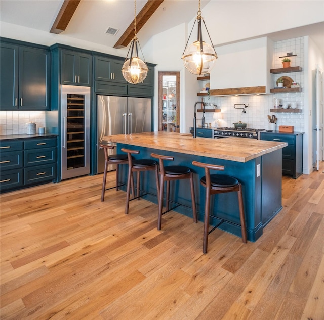 kitchen with open shelves, wine cooler, high end refrigerator, and wood counters