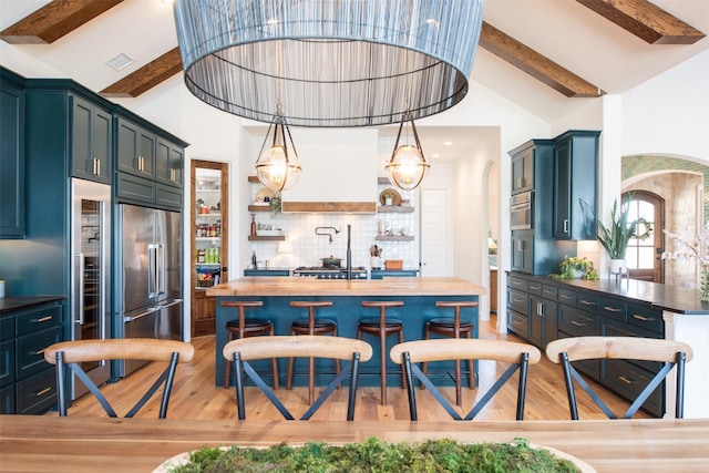 kitchen featuring tasteful backsplash, visible vents, wooden counters, light wood-type flooring, and beamed ceiling