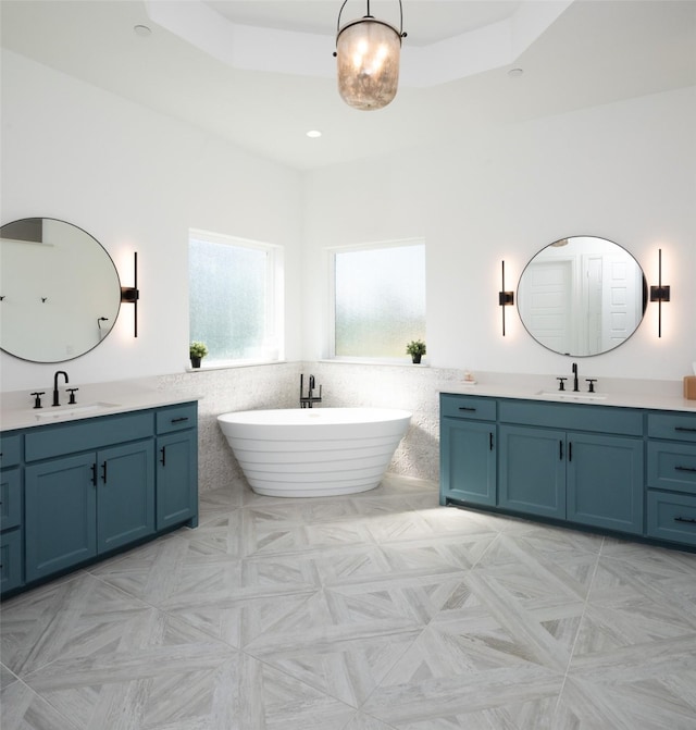 910 Greenacres Ln, Lucas, TX 75002 - full bath with a freestanding tub, tile walls, a sink, and two vanities