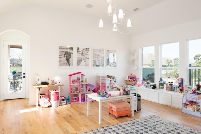 playroom with a chandelier, light wood-type flooring, and visible vents