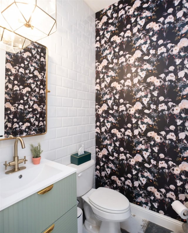 bathroom with toilet, a shower with curtain, tile walls, and vanity