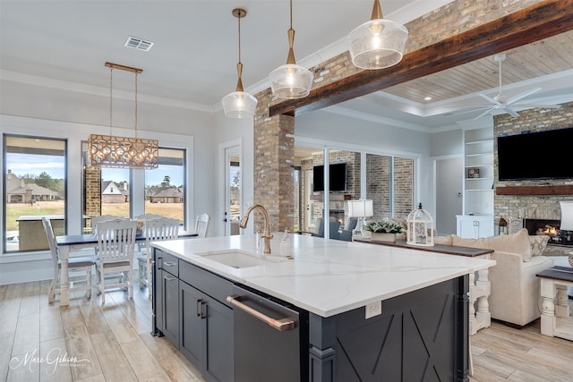 kitchen with open floor plan, visible vents, a sink, and dishwasher