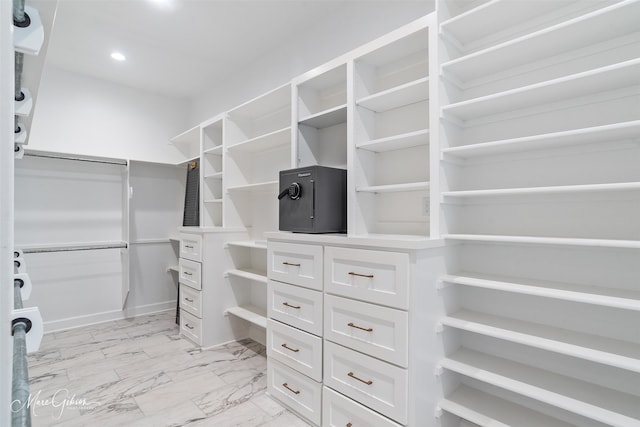 spacious closet featuring marble finish floor