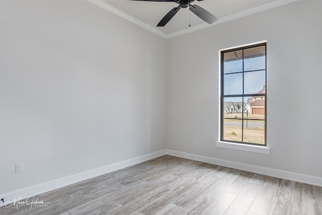 unfurnished room with a ceiling fan, baseboards, crown molding, and light wood finished floors