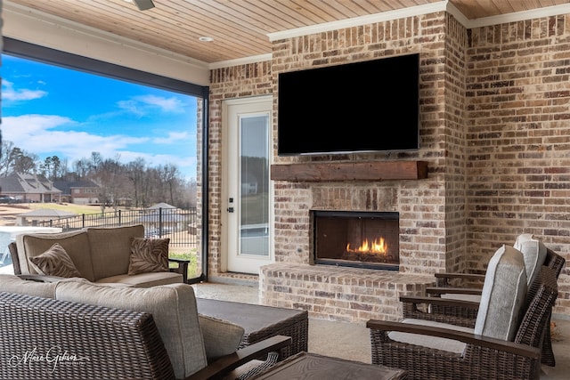 view of patio / terrace with an outdoor living space with a fireplace and fence