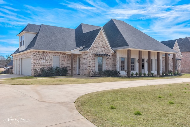 view of front of house with brick siding, concrete driveway, roof with shingles, a front lawn, and board and batten siding