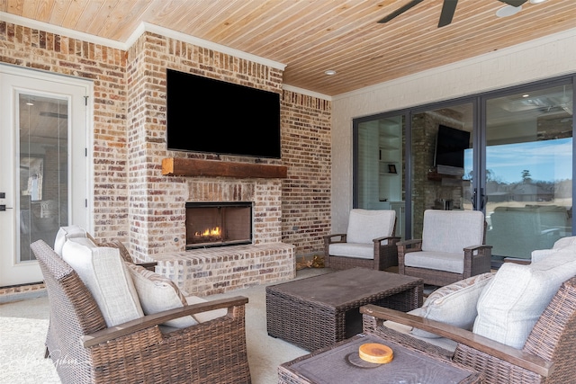 view of patio / terrace featuring ceiling fan and an outdoor living space with a fireplace