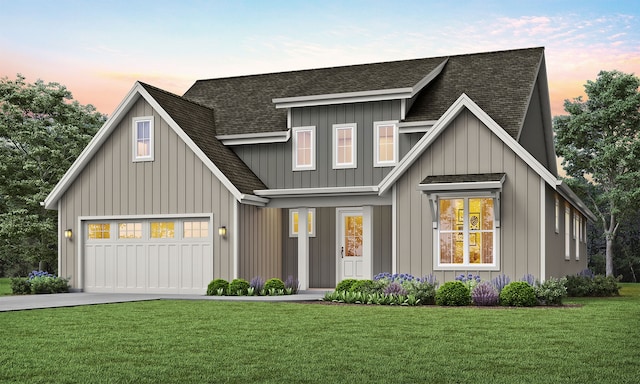 modern farmhouse style home featuring driveway, a shingled roof, board and batten siding, and a yard