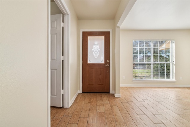 entrance foyer featuring light wood finished floors and baseboards