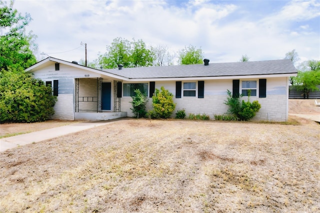 single story home with a porch and fence