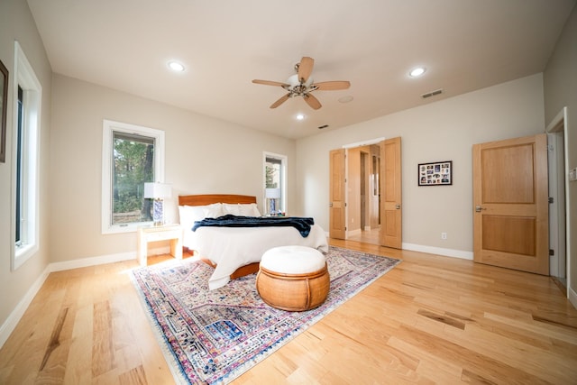 bedroom featuring baseboards, light wood finished floors, visible vents, and recessed lighting