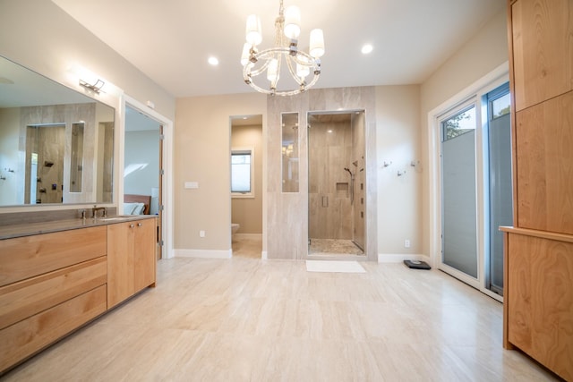 full bath featuring baseboards, toilet, an inviting chandelier, vanity, and a shower stall