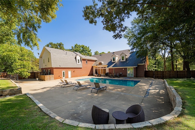 view of swimming pool with a fenced in pool, a patio area, a yard, and a fenced backyard