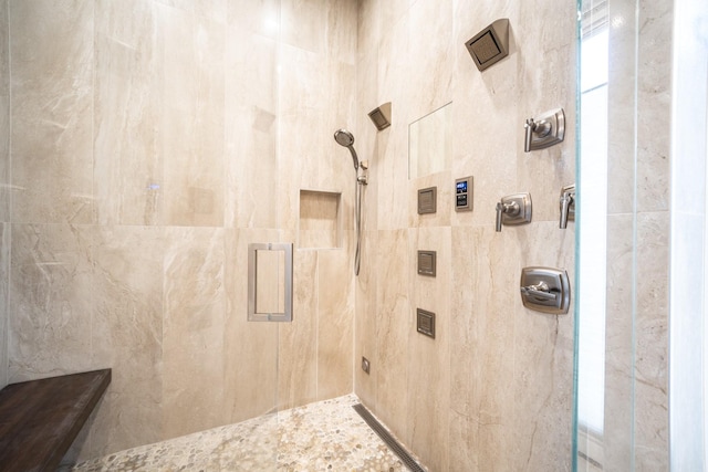 full bath featuring a tile shower