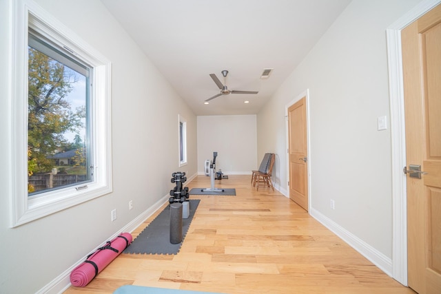 exercise area featuring light wood-style flooring, visible vents, baseboards, and recessed lighting