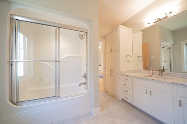 bathroom featuring bath / shower combo with glass door and vanity