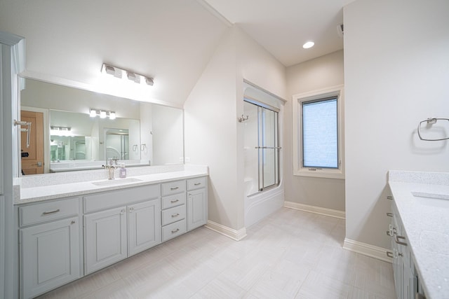 full bathroom with baseboards, bath / shower combo with glass door, and vanity