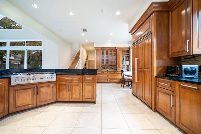 kitchen featuring stainless steel gas cooktop, tasteful backsplash, recessed lighting, and brown cabinets