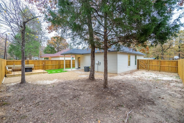 rear view of house featuring a fenced backyard