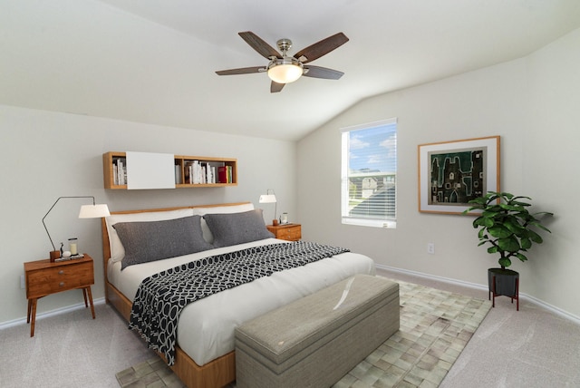 bedroom featuring baseboards, vaulted ceiling, a ceiling fan, and light colored carpet