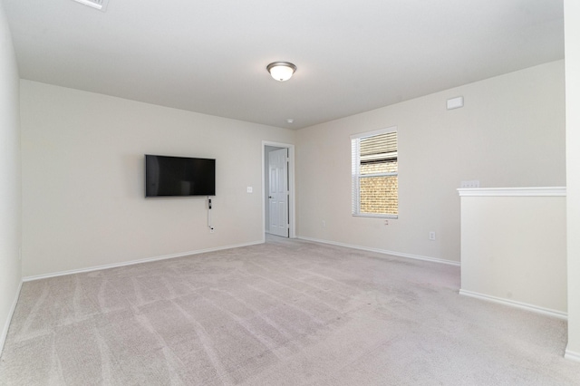 interior space featuring baseboards and light colored carpet