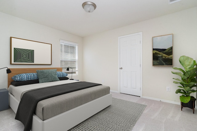 carpeted bedroom featuring visible vents and baseboards