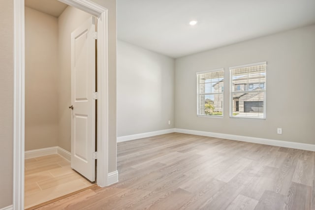 unfurnished room featuring recessed lighting, baseboards, and light wood finished floors