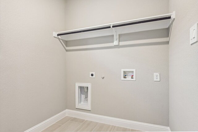 washroom featuring laundry area, baseboards, gas dryer hookup, hookup for a washing machine, and electric dryer hookup