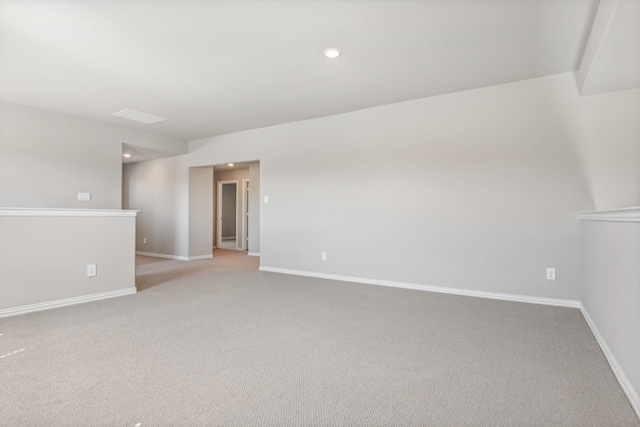 empty room with light carpet, recessed lighting, and baseboards