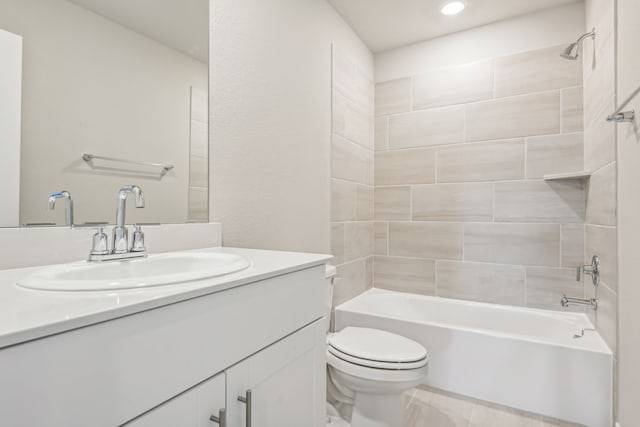 bathroom with tub / shower combination, vanity, and toilet