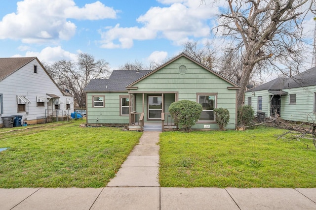 bungalow-style home featuring a porch and a front yard