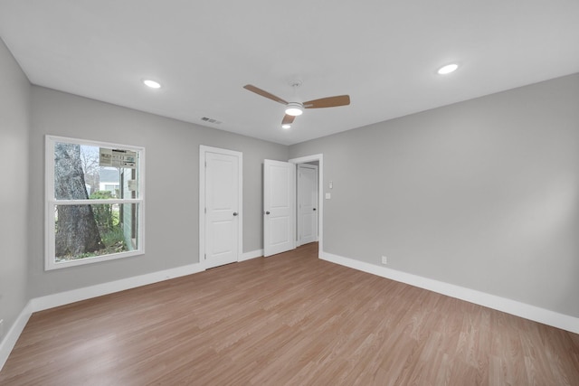 unfurnished bedroom featuring visible vents, recessed lighting, light wood-style floors, and baseboards