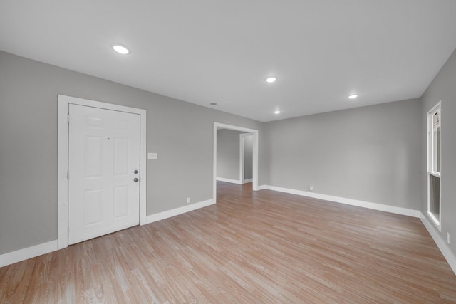 unfurnished room featuring recessed lighting, light wood-style flooring, and baseboards