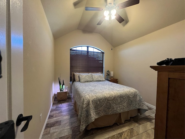 bedroom with a ceiling fan, lofted ceiling, and baseboards