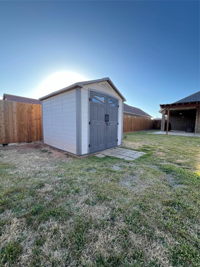 view of shed with a fenced backyard