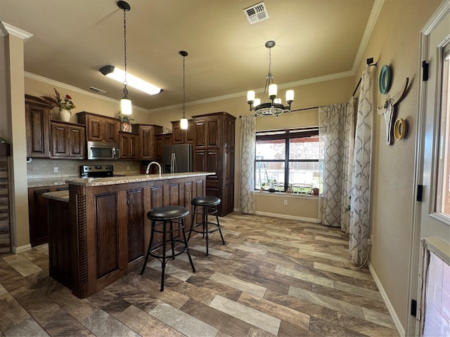 kitchen with visible vents, appliances with stainless steel finishes, dark brown cabinets, and ornamental molding