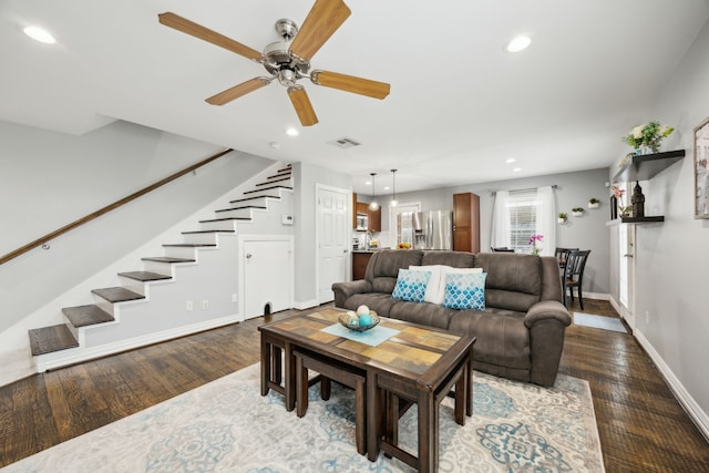 living room with stairway, wood finished floors, visible vents, and recessed lighting