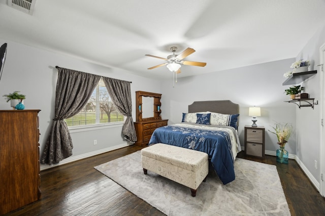 bedroom featuring ceiling fan, wood finished floors, visible vents, and baseboards