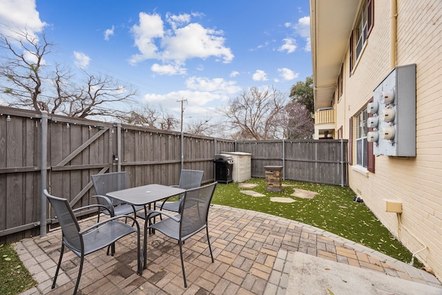 view of patio featuring a fenced backyard and outdoor dining area