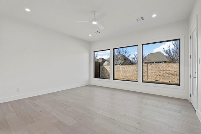 unfurnished room with light wood-style flooring, visible vents, and recessed lighting